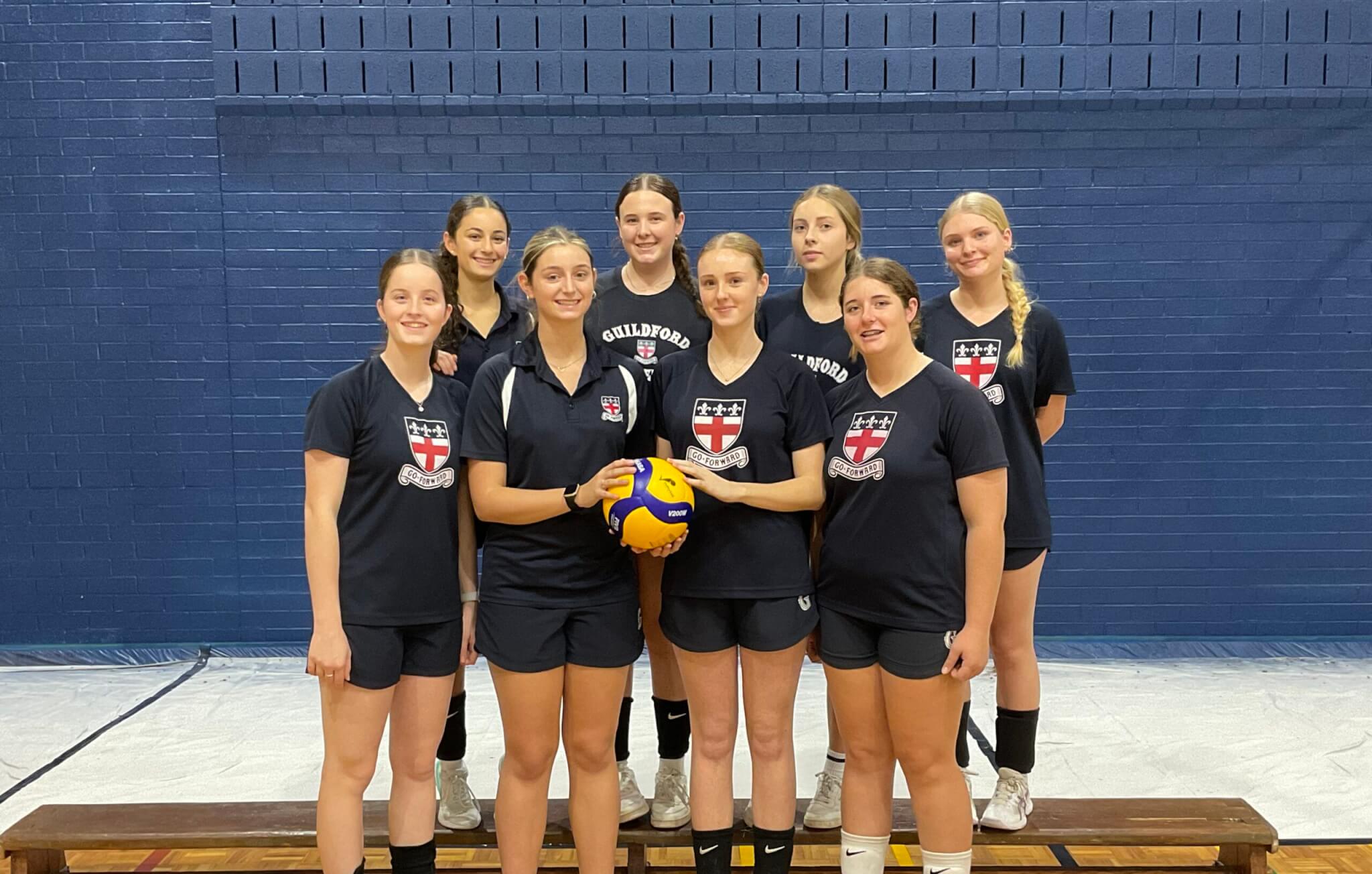 GGS Volleyball First Team players gathered on the court before a match, representing both the Boys and Girls programs