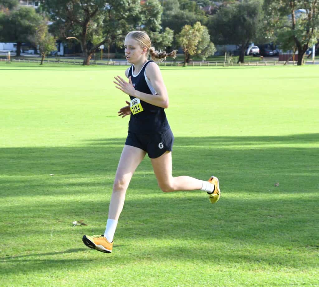Girls running during a school sports event at Guildford Grammar School.