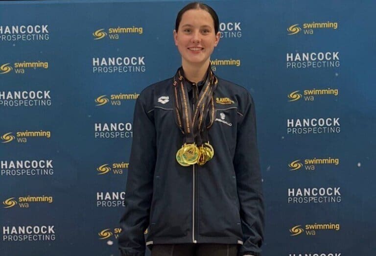 Young female swimmer with medals at Hancock Prospecting State Championships.